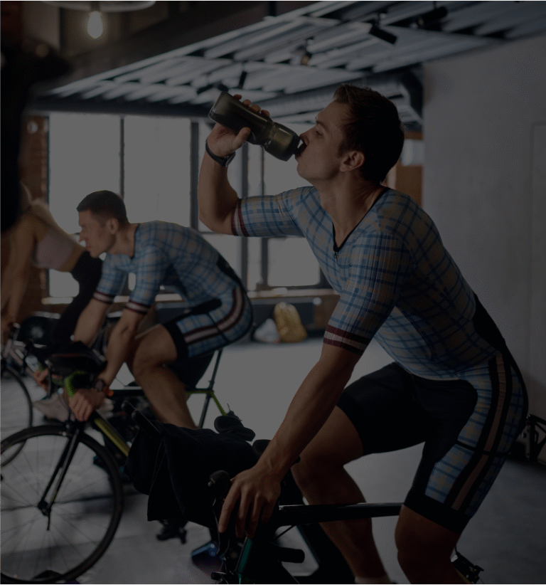 sportsman-drinking-water-training-stationary-bike 1